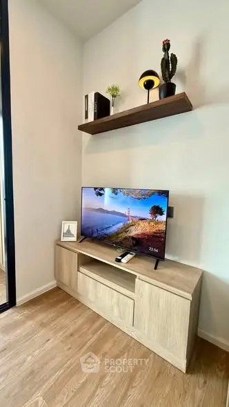 Modern living room with stylish TV setup and wooden flooring