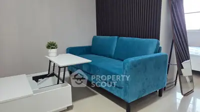 Modern living room with blue sofa and sleek furniture