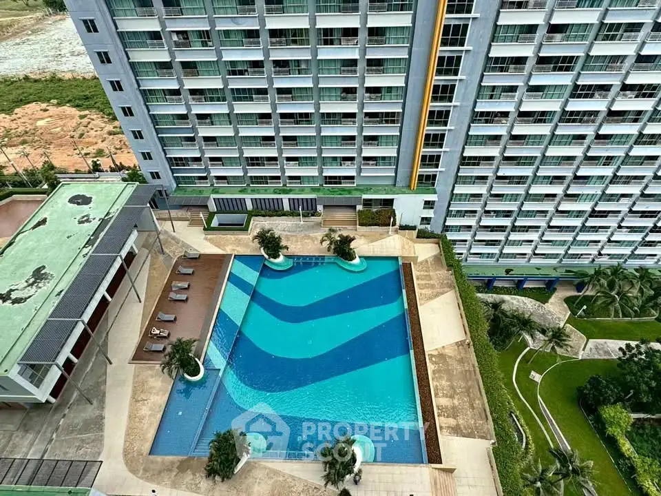 Luxurious high-rise building with stunning pool and lush garden view