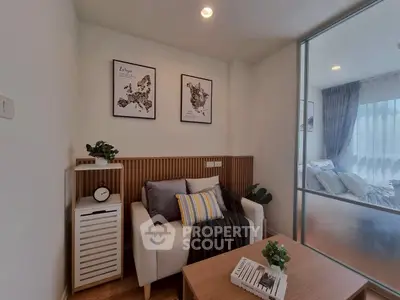 Cozy living room with modern decor and glass partition to bedroom