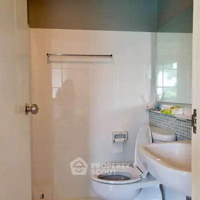 Modern bathroom with sleek fixtures and tiled walls, perfect for a contemporary home.