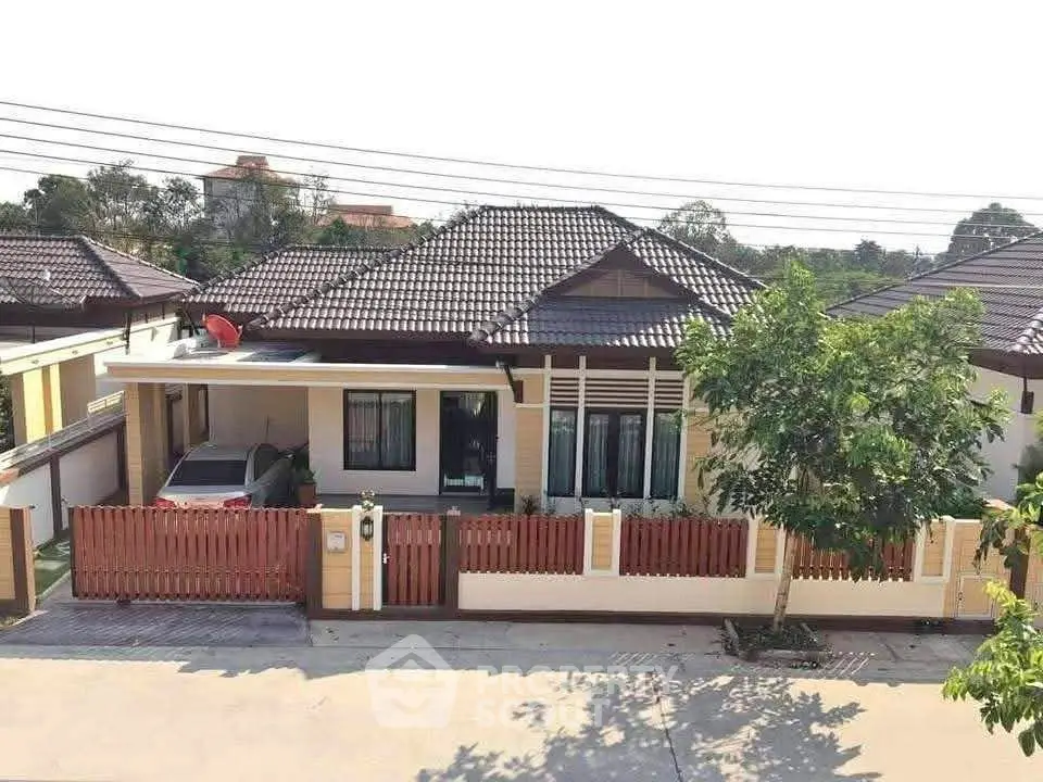 Charming single-story house with tiled roof and carport in a serene neighborhood.