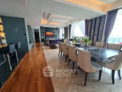 Luxurious open-plan living and dining area with elegant decor and stunning views