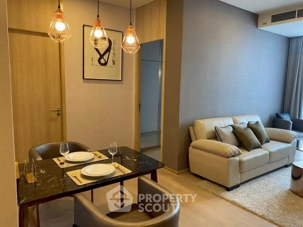 Modern living room with elegant dining area and cozy seating, perfect for relaxation and entertaining.