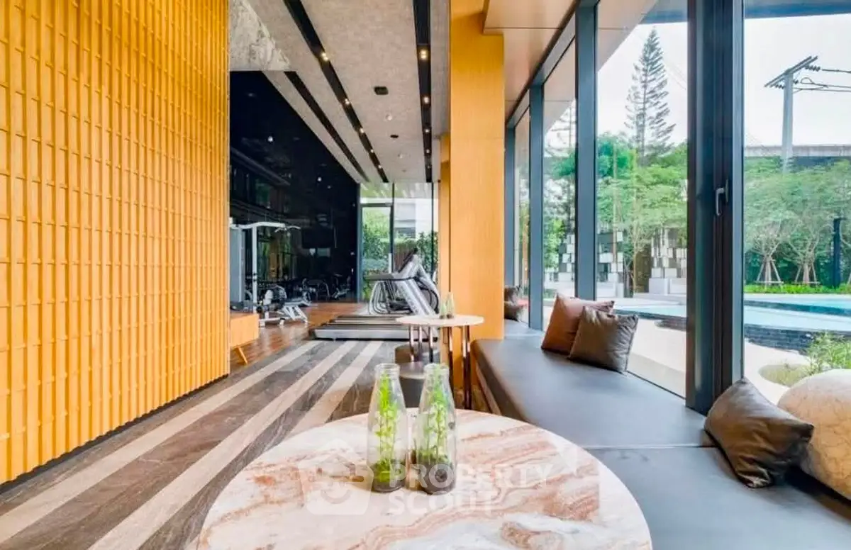 Luxurious gym with pool view and modern interior design