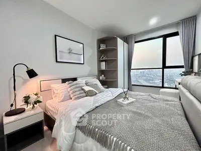 Modern bedroom with city view, cozy decor, and stylish furnishings.