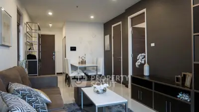 Modern living room with stylish decor and dining area in open layout apartment.