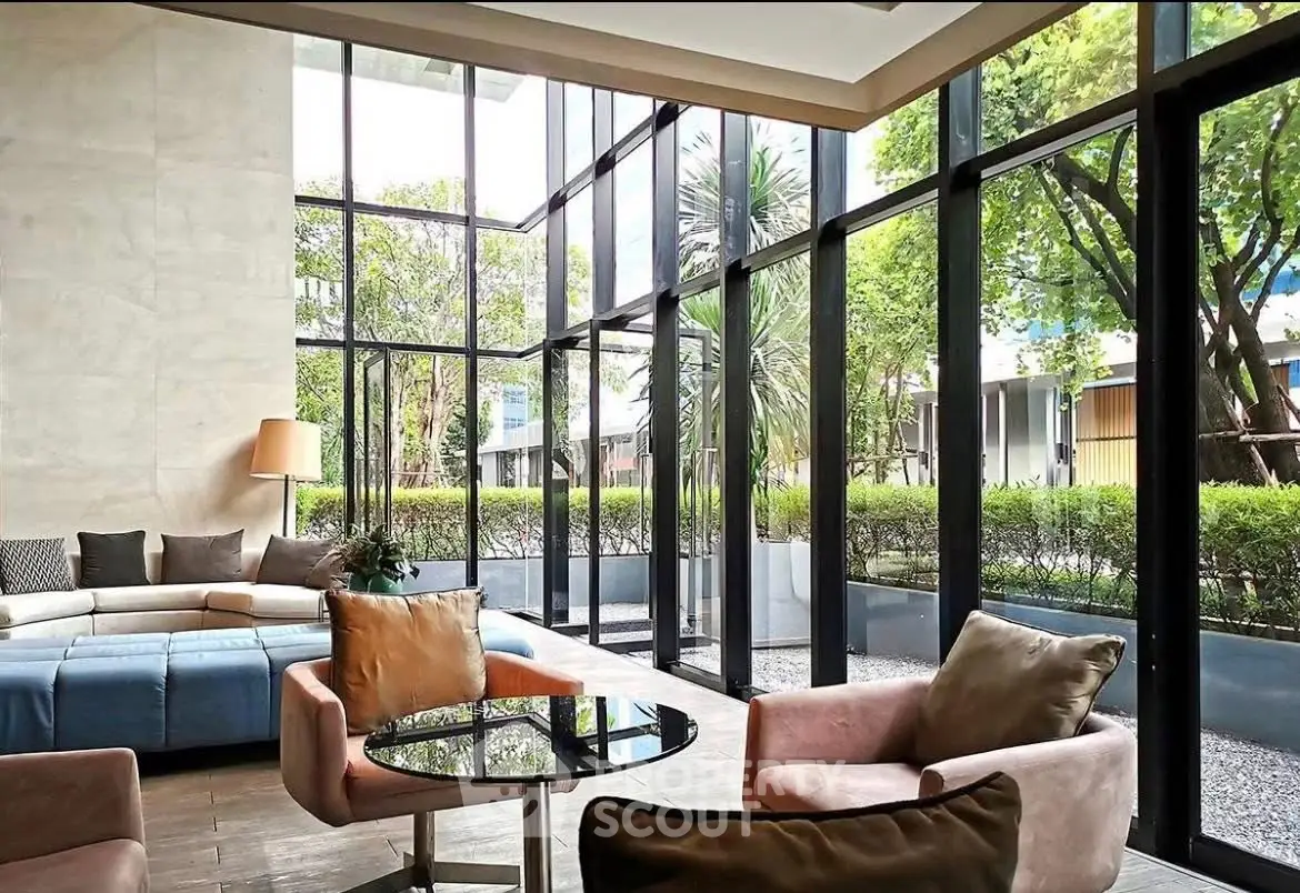 Luxurious living room with floor-to-ceiling windows and garden view