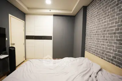 Modern bedroom with stylish brick accent wall and built-in wardrobe