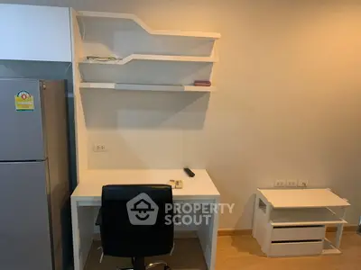 Modern study area with desk, chair, and shelves in a stylish apartment.