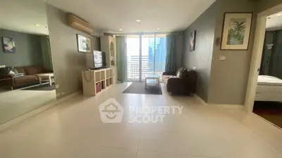 Spacious living room with modern decor and balcony view in urban apartment