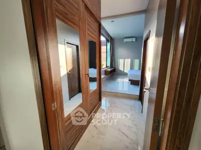Luxurious bedroom entrance with mirrored closet and marble flooring