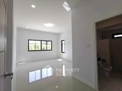 Spacious modern room with glossy tile flooring and large windows