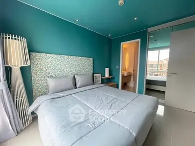 Modern bedroom with teal accents and large window view