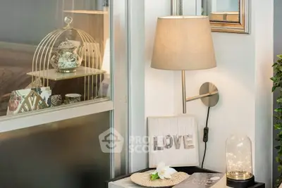 Charming interior corner with elegant decor and soft lighting, perfect for cozy living spaces.