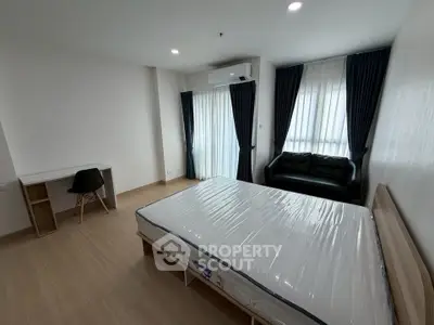 Spacious bedroom with modern furnishings and natural light