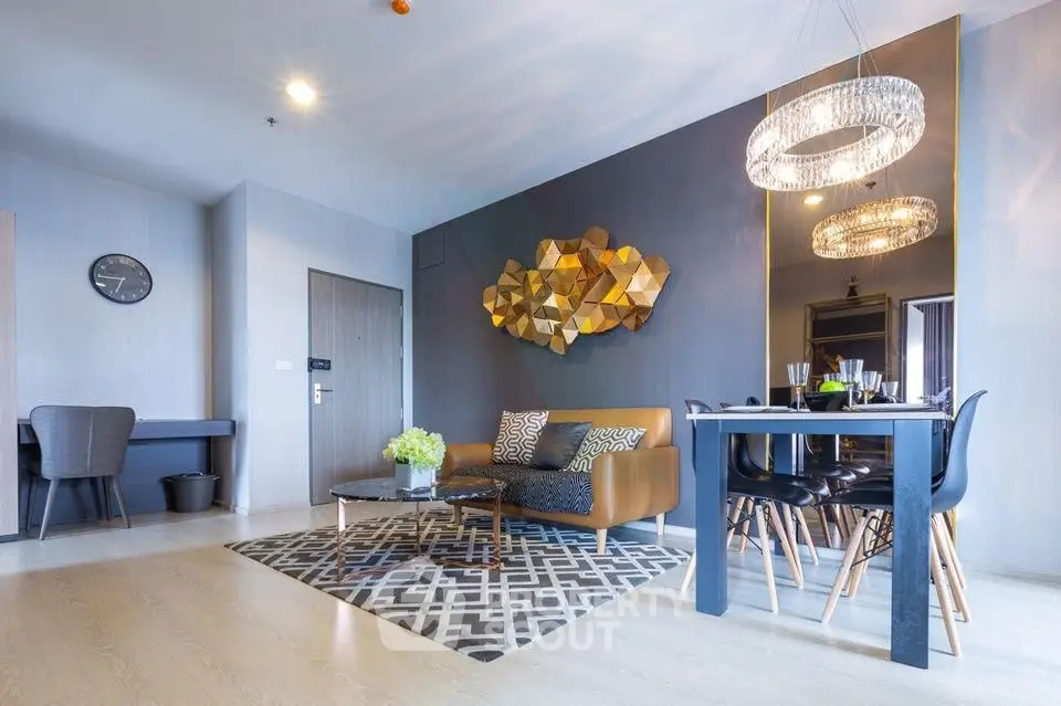 Modern living room with stylish decor and dining area, featuring elegant lighting and contemporary furniture.