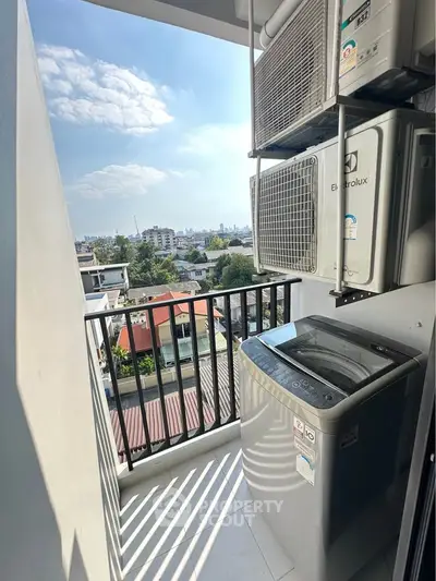 Charming balcony with city view and modern washing machine, perfect for urban living.