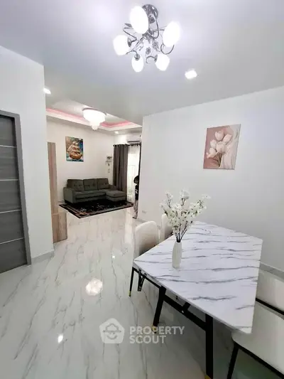 Elegant living and dining area with modern decor and marble flooring