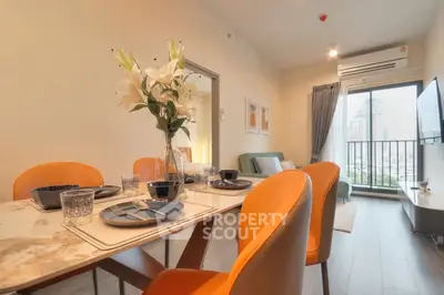 Modern dining area with elegant table setting and city view balcony