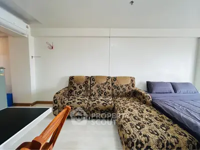 Spacious living room with stylish sofa and cozy bed in modern apartment