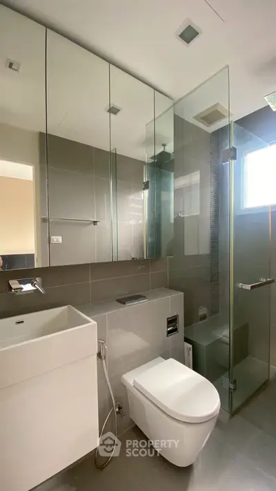 Modern bathroom with sleek fixtures and glass shower enclosure