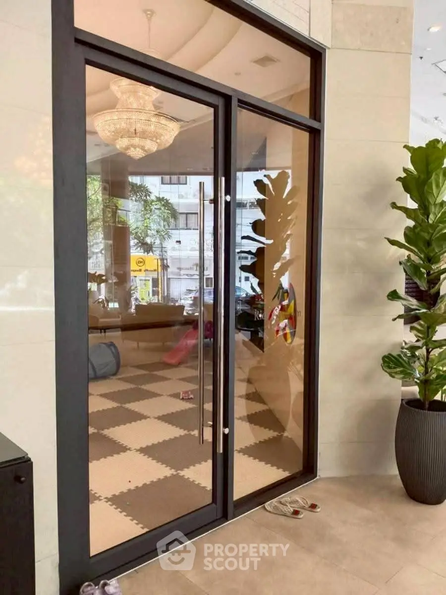 Elegant building entrance with glass doors and modern decor
