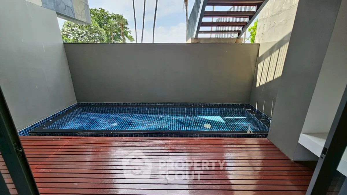 Luxurious private pool with wooden deck in modern home