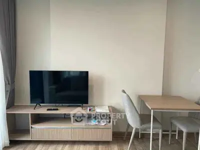 Modern living room with sleek TV stand and cozy dining area, perfect for urban living.