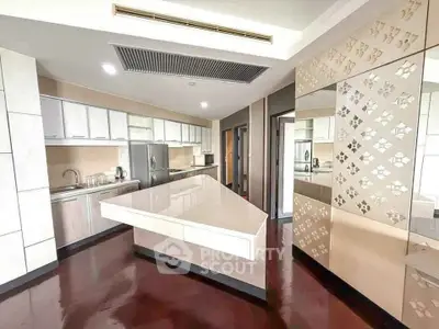 Luxurious modern kitchen with sleek design and spacious layout, featuring high-end appliances and elegant finishes.