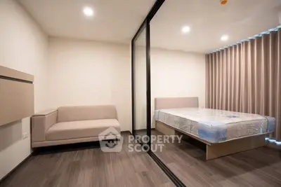 Modern minimalist bedroom with glass partition and cozy sofa