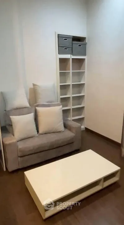 Cozy living room with modern sofa and sleek shelving unit, perfect for urban living.