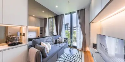 Modern living room with sleek design, large windows, and stylish furniture in a high-rise apartment.