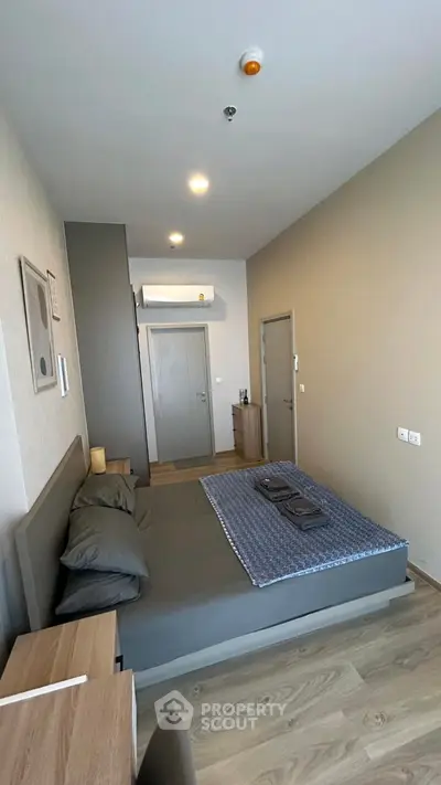 Modern bedroom with sleek design and cozy ambiance, featuring stylish furniture and neutral tones.