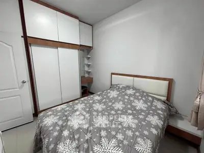 Cozy bedroom with modern built-in wardrobe and stylish bed in a minimalist design.