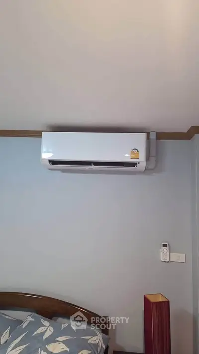 Modern bedroom with air conditioning unit and stylish decor