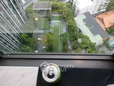 Stunning aerial view of modern urban garden from high-rise building window.