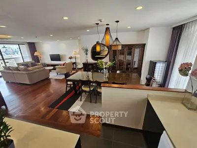 Spacious open-plan living and dining area with modern decor and large windows.