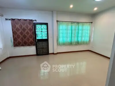 Spacious unfurnished room with tiled flooring and large windows, perfect for customization.