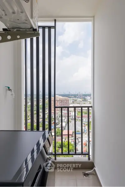 High-rise apartment balcony with stunning city view and modern appliances.