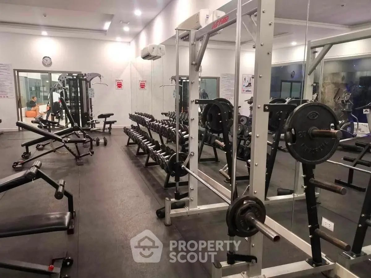 Spacious modern gym with state-of-the-art equipment in a luxury residential building.