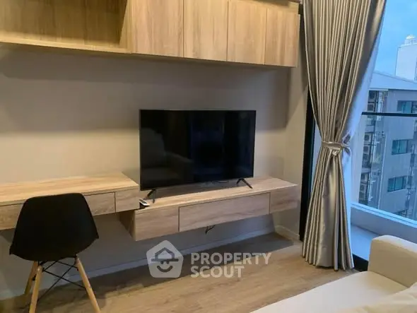 Modern living room with sleek TV setup and stylish wooden furniture