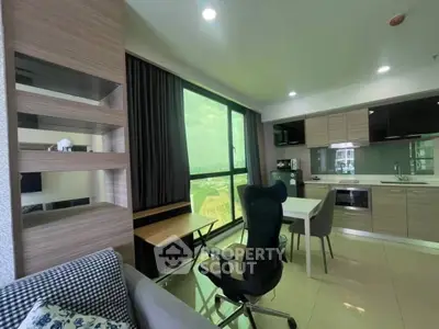 Modern open-layout living room with kitchen, featuring sleek furniture and large window with a view.
