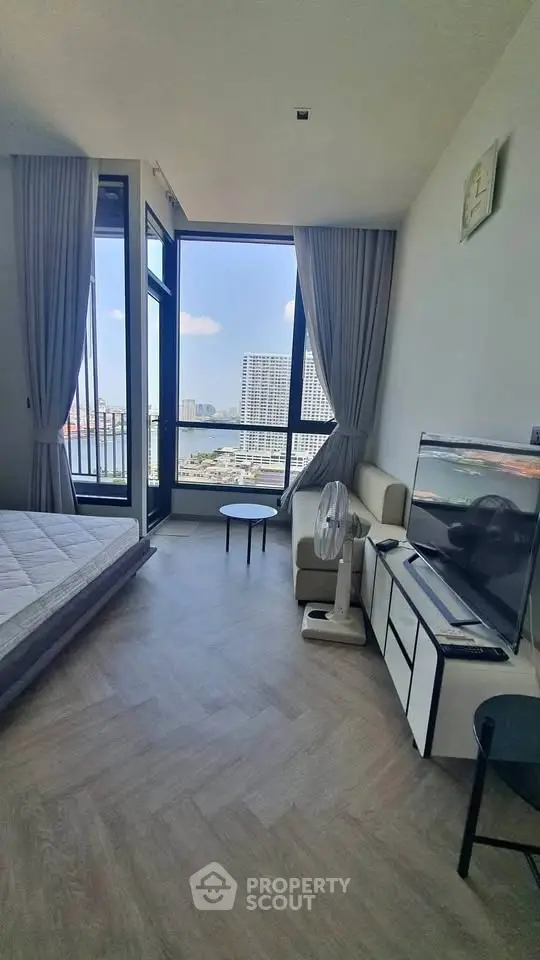 Modern bedroom with stunning city view, large windows, and stylish decor in a high-rise apartment.