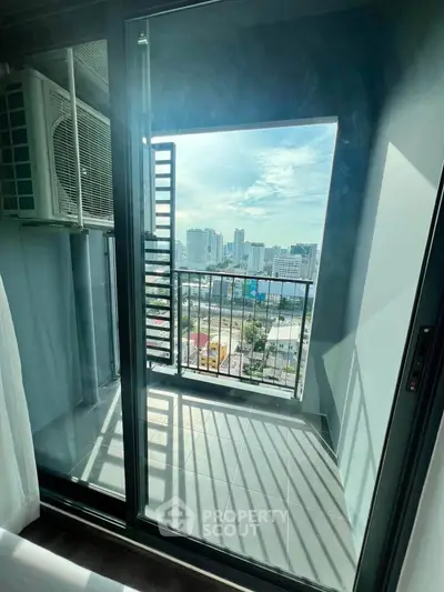 Modern balcony with city view and air conditioning unit, perfect for urban living.