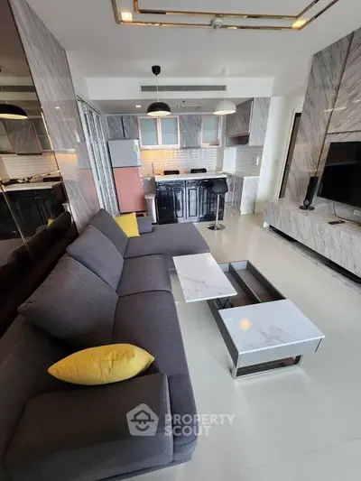 Modern living room with sleek kitchen and stylish decor