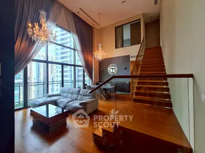 Luxurious duplex living room with high ceilings, chandeliers, and city view