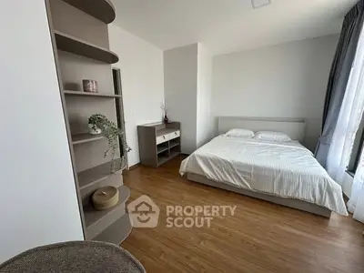 Spacious bedroom with modern decor and natural light