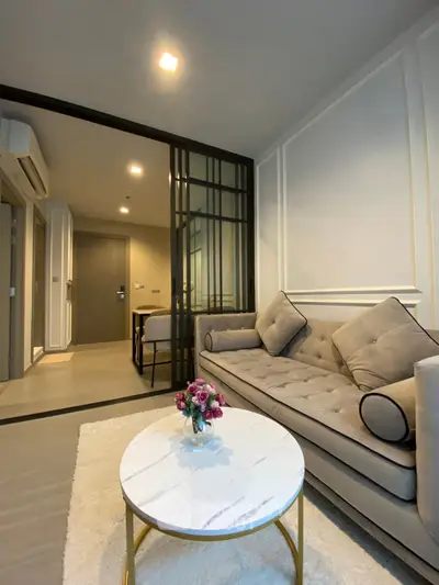 Modern living room with elegant sofa and stylish decor in a cozy apartment.