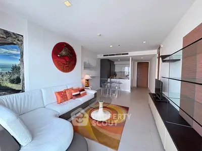 Spacious modern living room with ocean view, stylish decor, and open layout in luxury apartment.